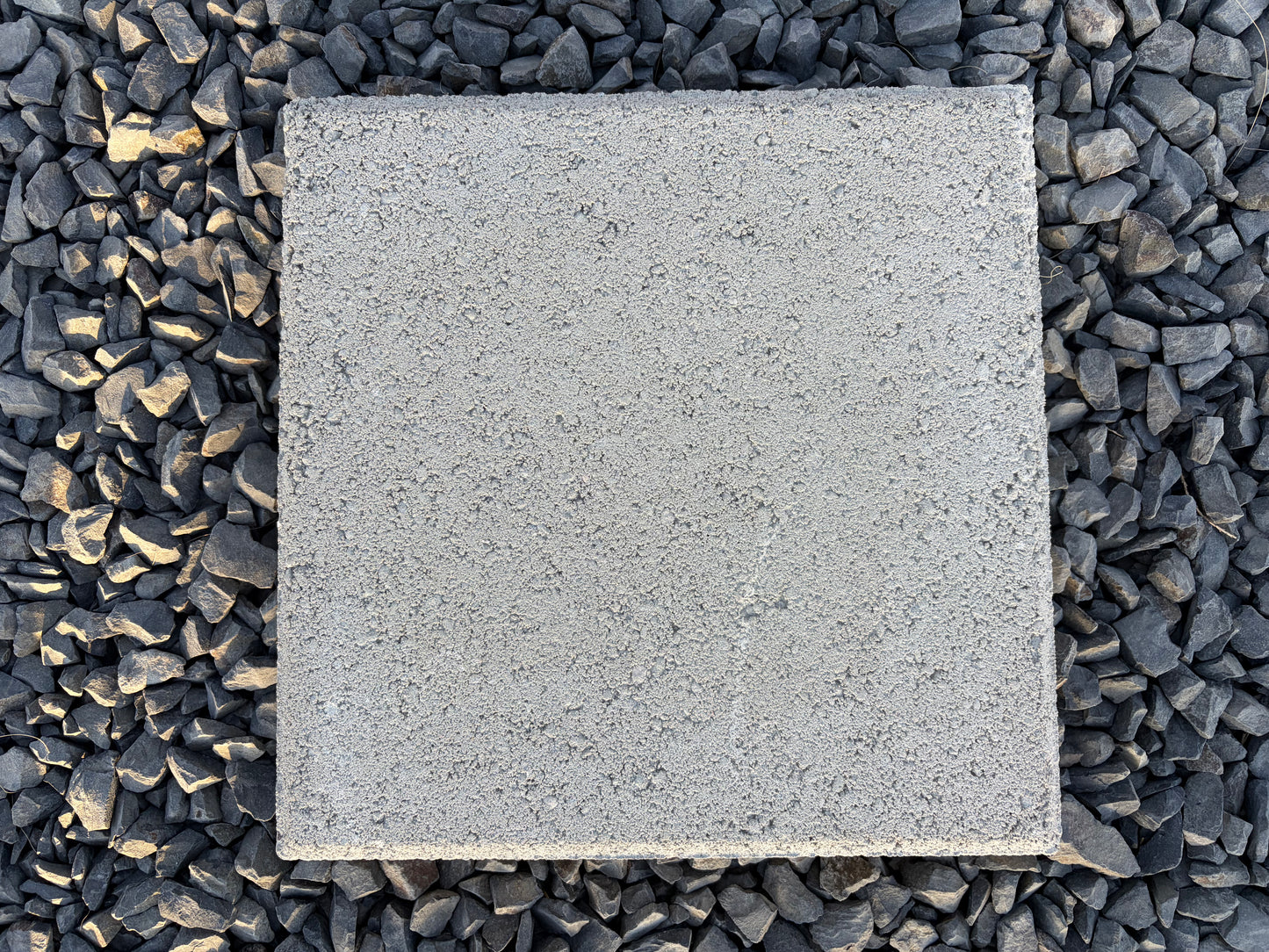 Grey Angelus 12x12 concrete stepping stone installed for garden paths and decorative rock landscaping