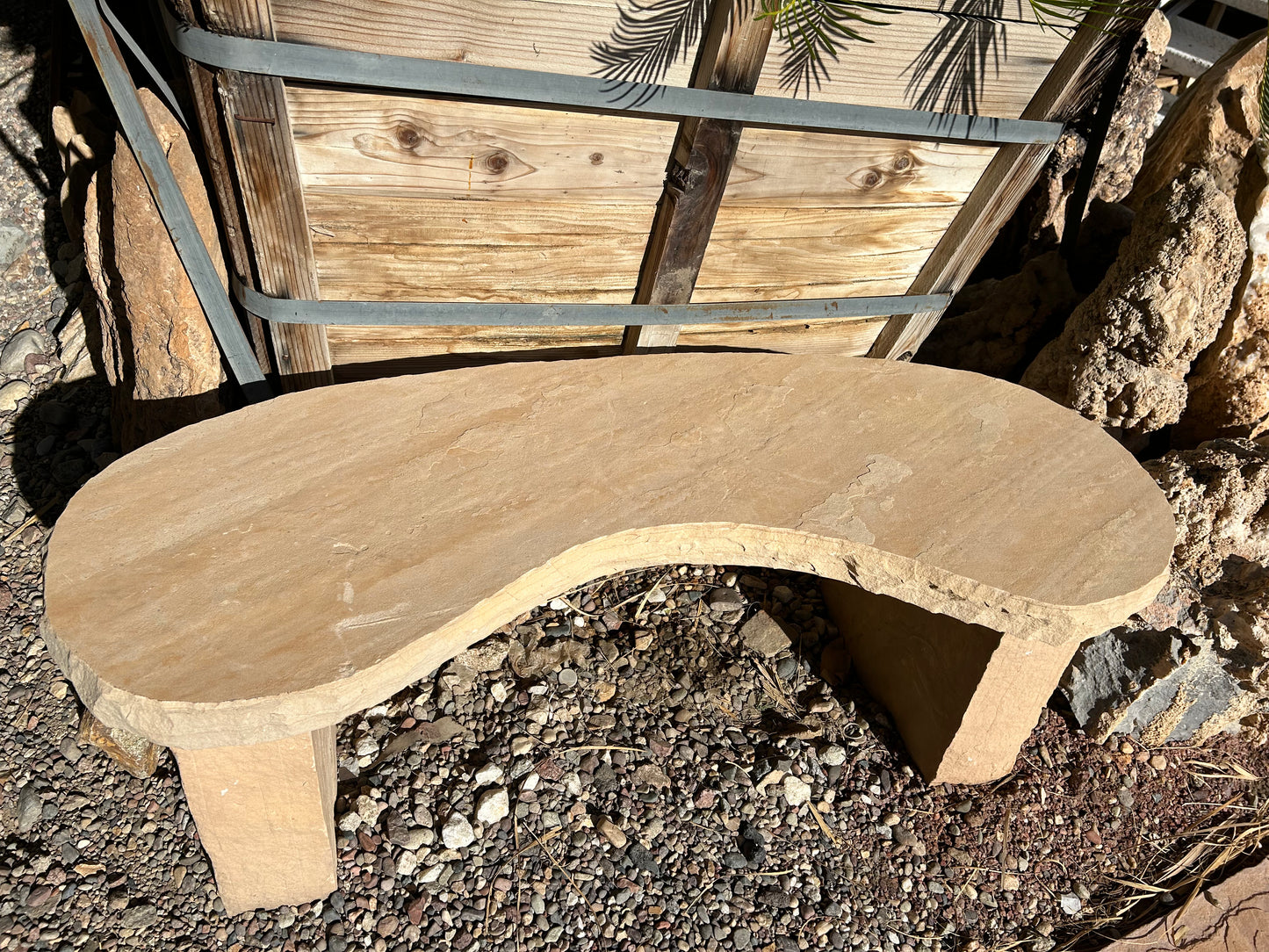 Custom three-piece flagstone kidney bench with curved stone seat