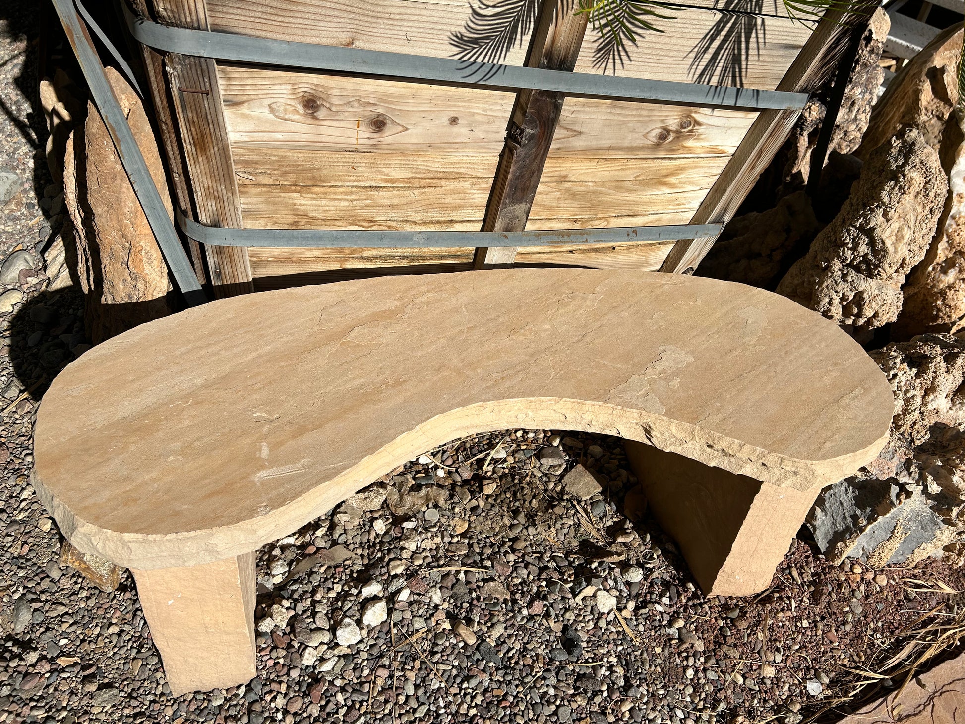 Custom three-piece flagstone kidney bench with curved stone seat