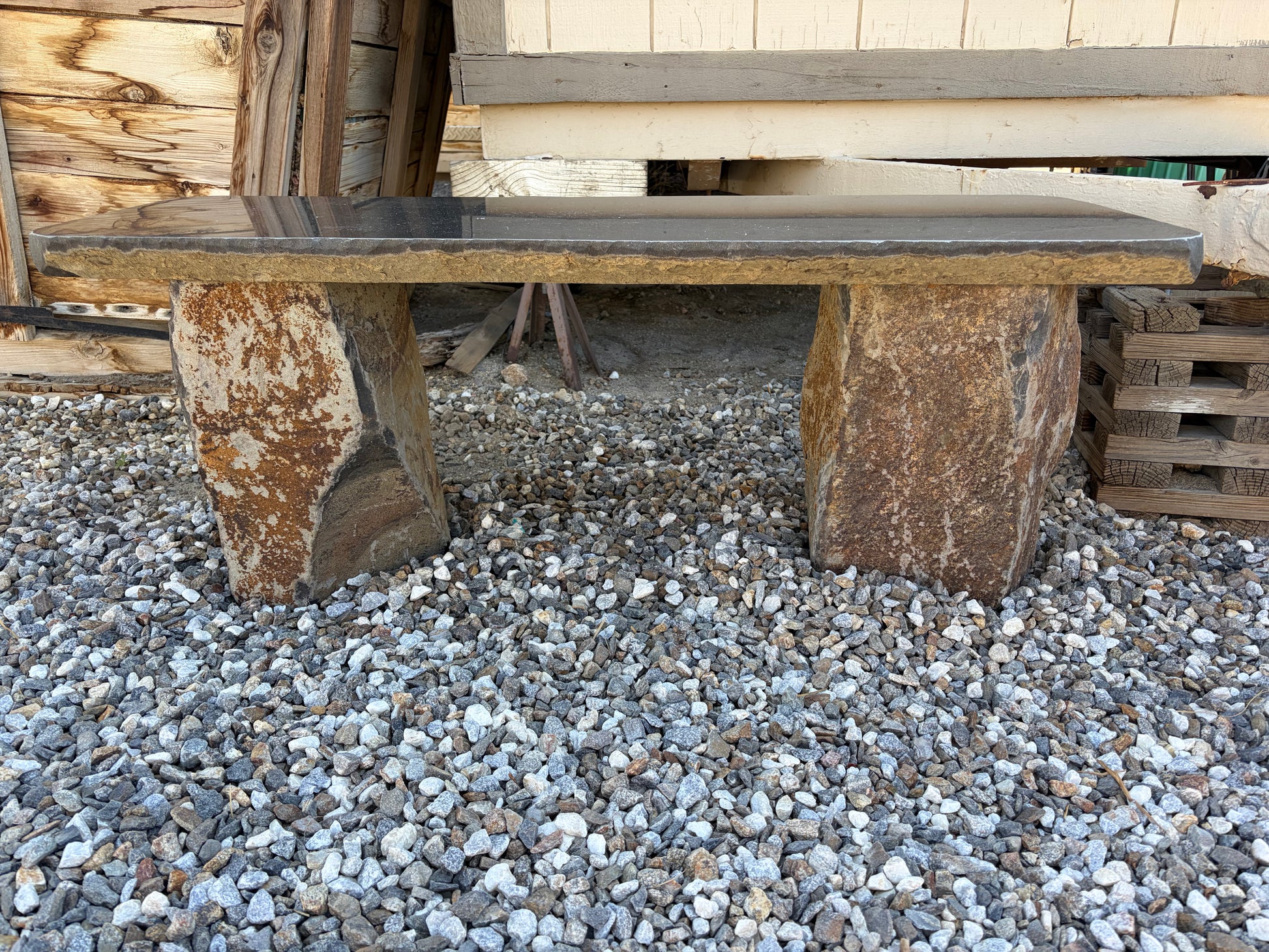 Close-up of polished basalt bench showing its smooth stone finish and natural dark gray coloring.