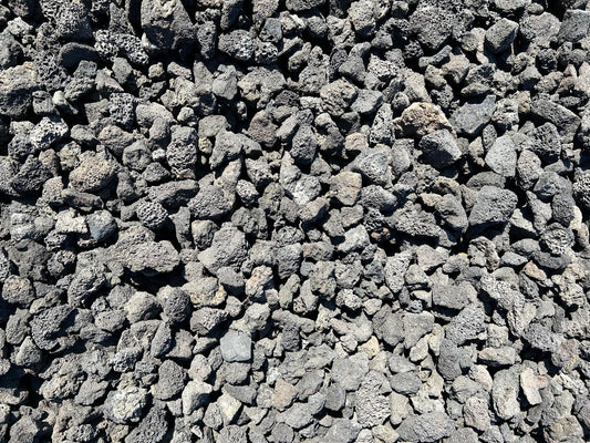 Black lava rock cinders with porous charcoal-black texture